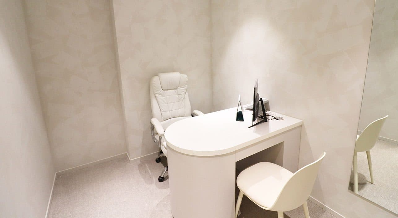 A consultation room at VG Plastic Surgery — the desk where you sit across from the surgeon